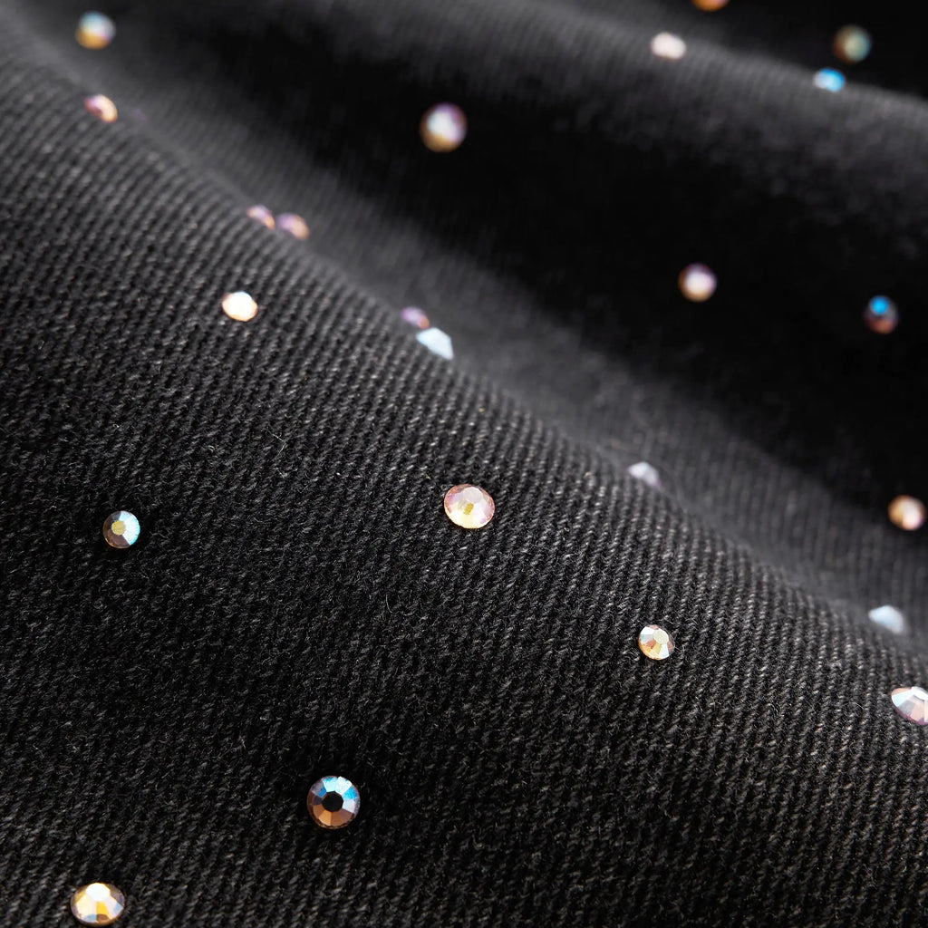 Acid washed rhinestone baggy jeans by INFLATION, featuring distressed details and a relaxed fit, shown on a model.