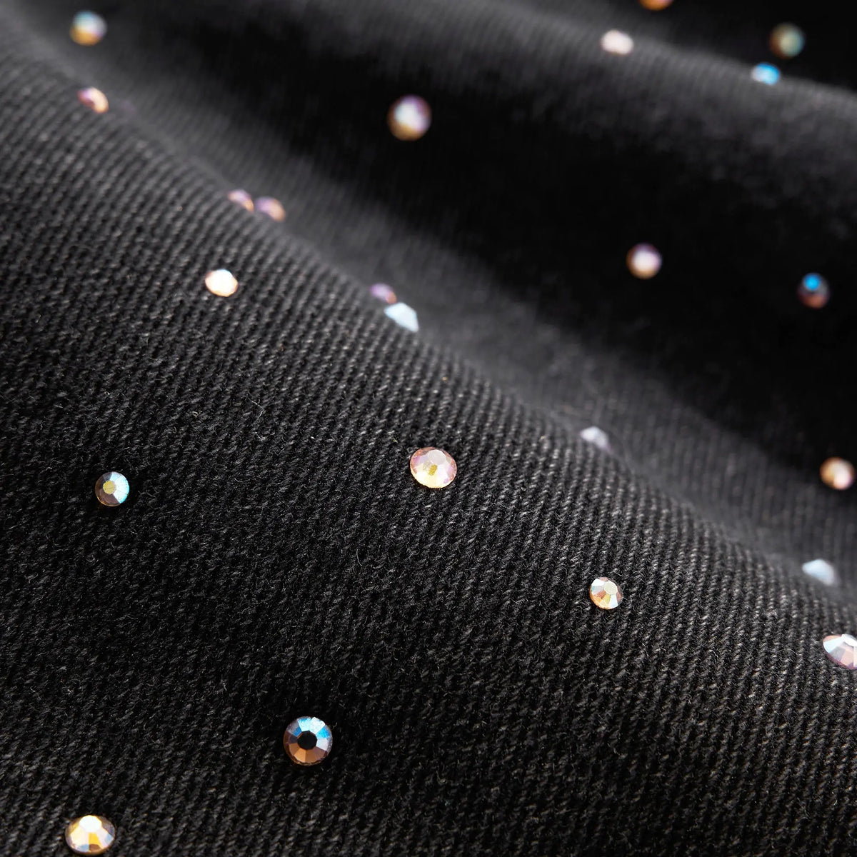 Acid washed rhinestone baggy jeans by INFLATION, featuring distressed details and a relaxed fit, shown on a model.
