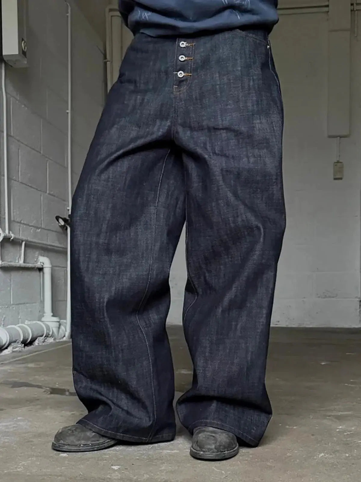 Pair of Inflation Streetwear Buttons Up Raw Baggy Jeans with relaxed fit and distressed details, front pockets, and button closure.