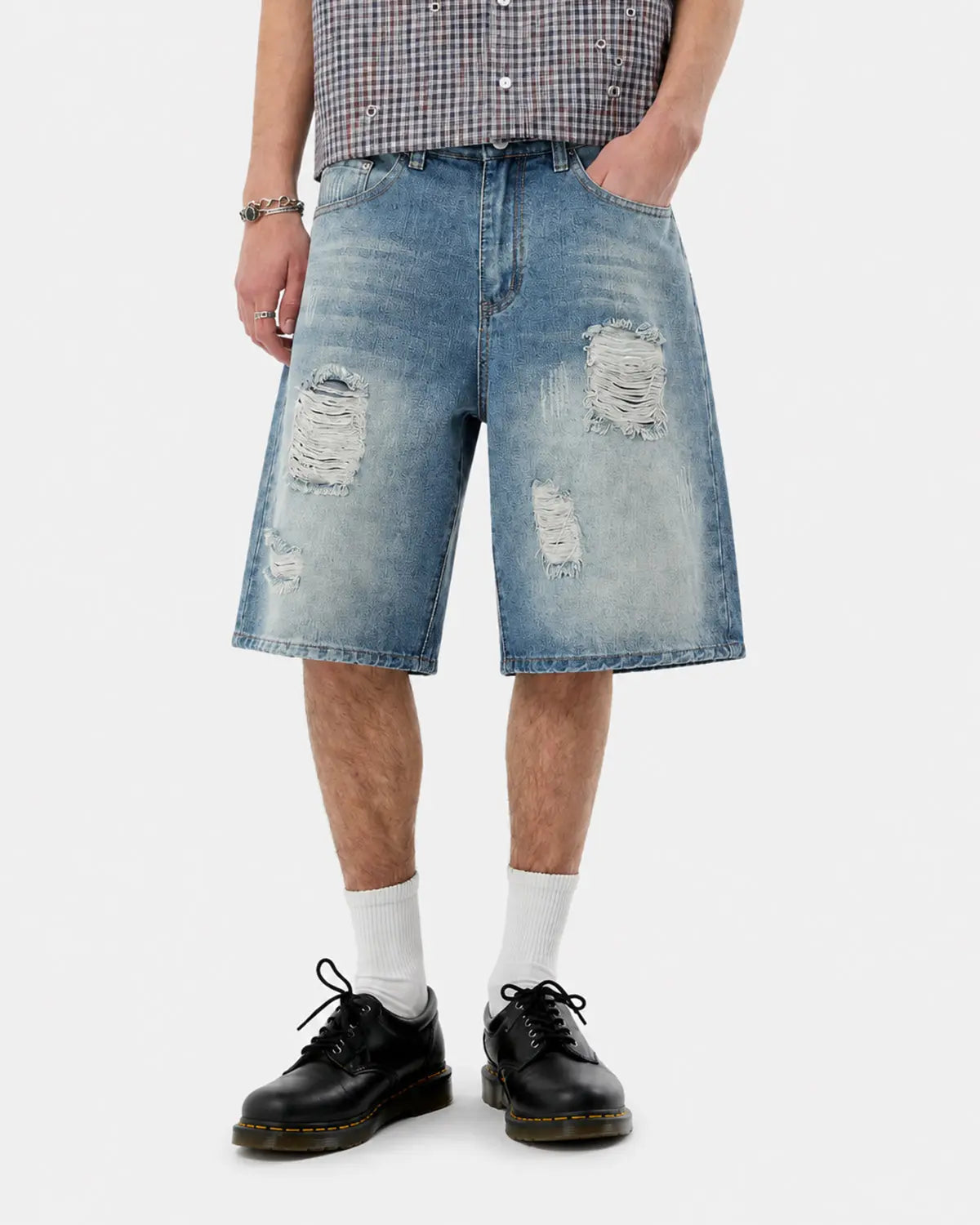 Distressed washed knee-length jorts by INFLATION, casual denim pants with frayed edges and worn finish, suitable for streetwear style.