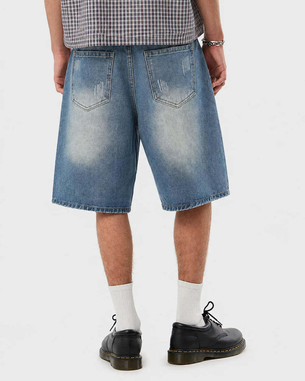 Distressed washed knee-length jorts by INFLATION, denim pants with frayed edges and a relaxed streetwear style.