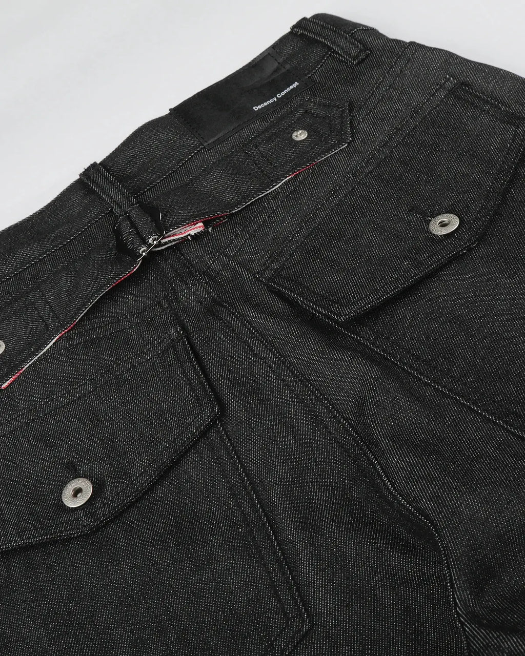 Deconstructed utility baggy jeans by INFLATION featuring distressed details and oversized fit, styled with multiple pockets.