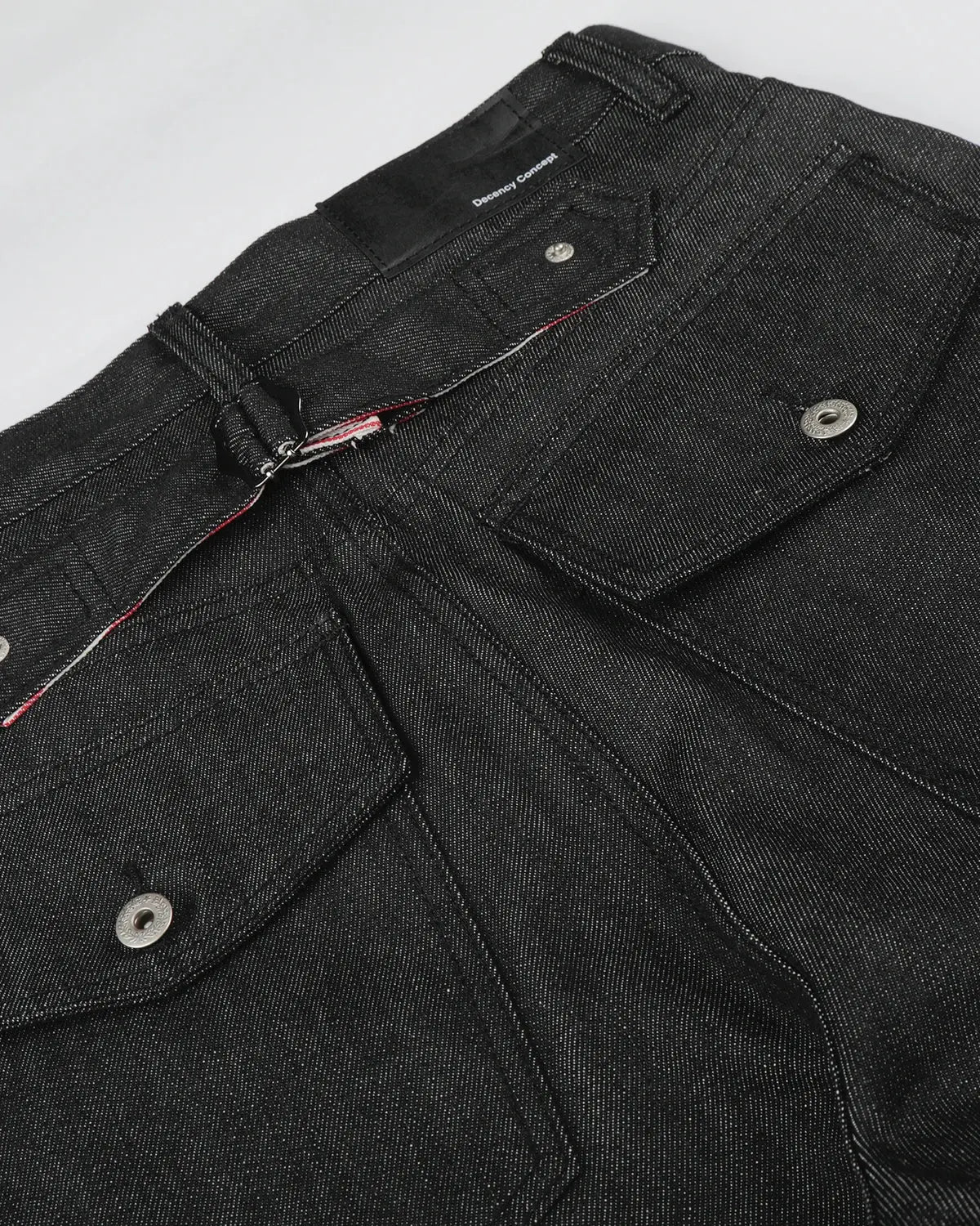 Deconstructed utility baggy jeans by INFLATION featuring distressed details and oversized fit, styled with multiple pockets.