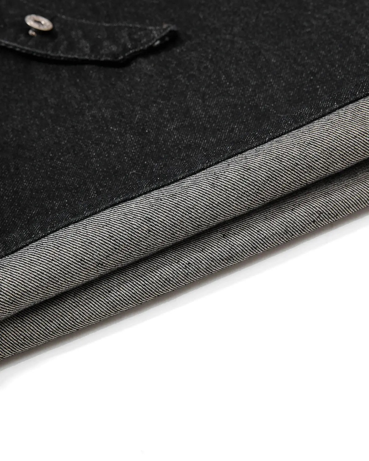 Asymmetric button raw denim jorts by INFLATION, featuring distressed raw denim fabric and unique button detailing.