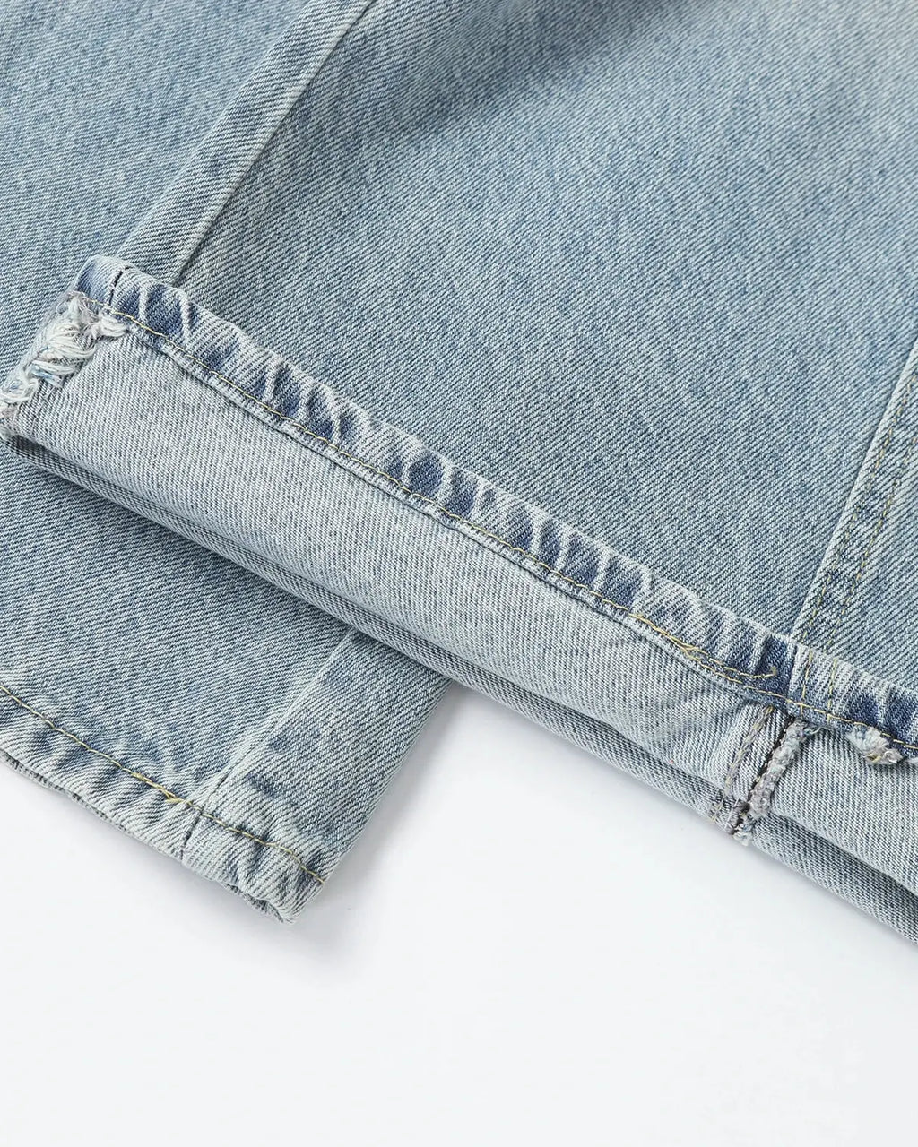 Asymmetric button baggy jeans from Inflation Streetwear featuring a relaxed fit and stylish design, displayed on a neutral background.