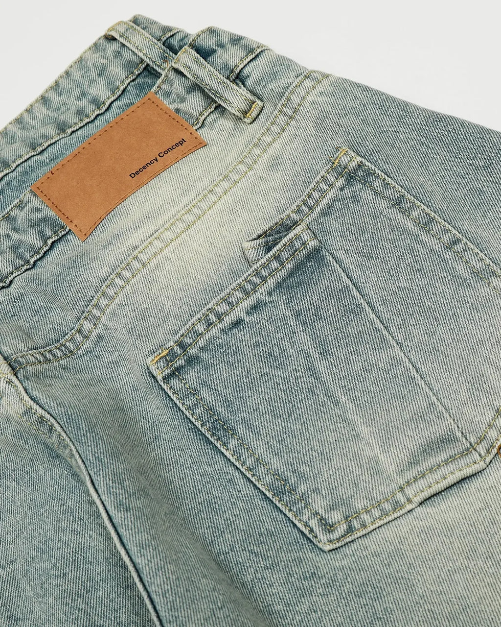 Acid washed double waist baggy jeans by INFLATION featuring a relaxed fit and streetwear style, shown on a model.