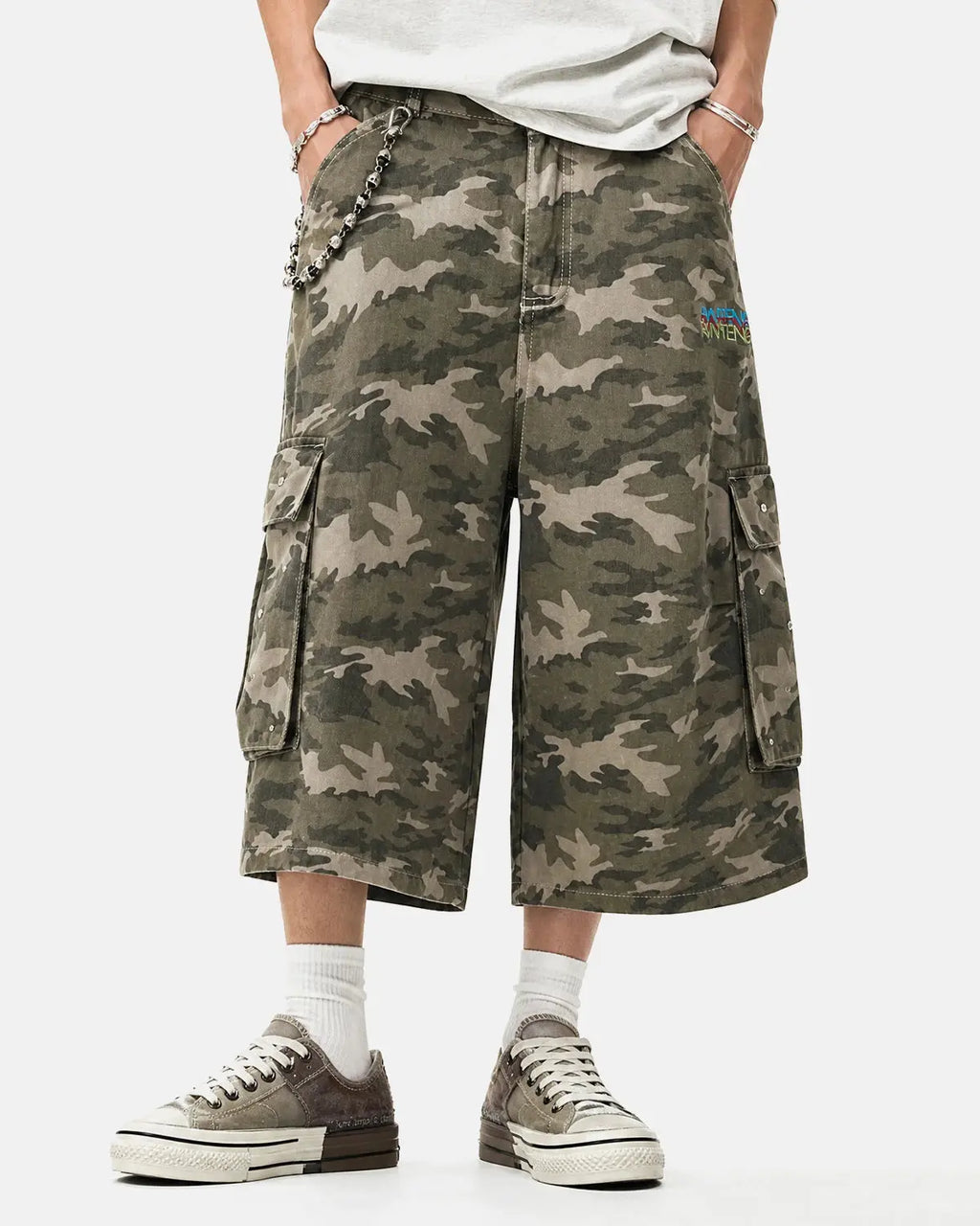 Embroidered camo cargo longline shorts by INFLATION, featuring a military-inspired pattern and multiple pockets.