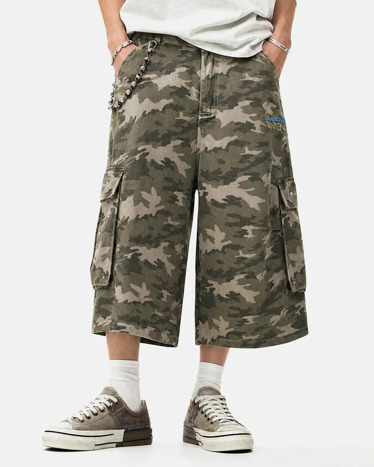 Embroidered camo cargo longline shorts by INFLATION, featuring a military-inspired pattern and multiple pockets.