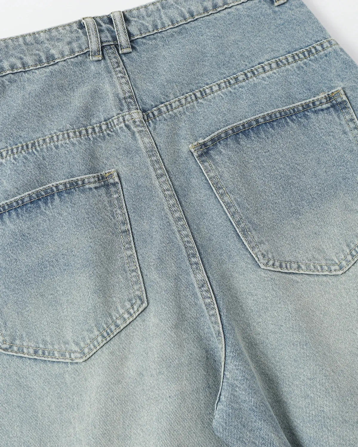 Inflation asymmetric button baggy jeans featuring a relaxed fit and stylish design, perfect for streetwear fashion.