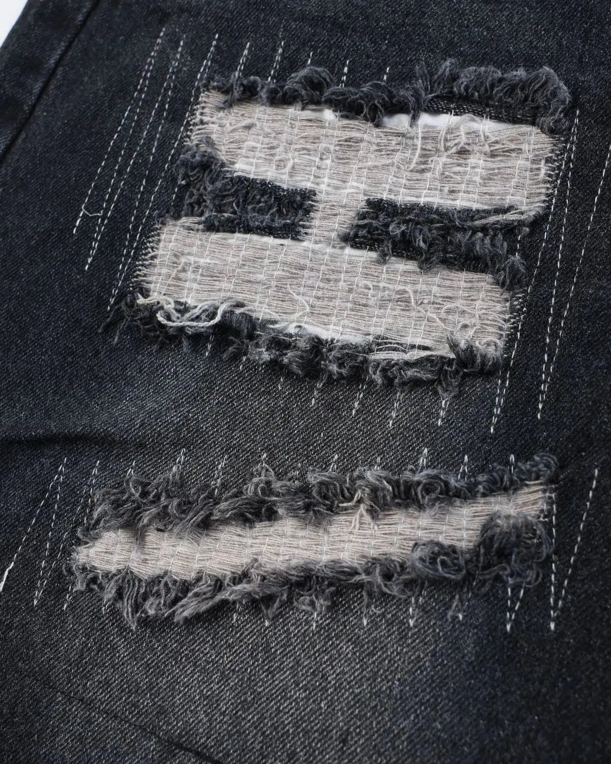 Inflation streetwear camo patchwork washed denim jorts, casual men's pants with distressed details and rugged style.