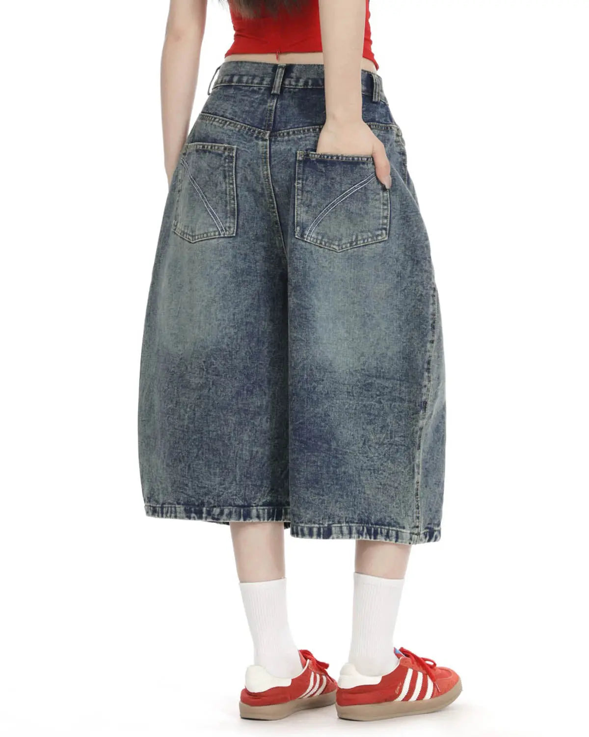 Inflation Streetwear studded washed long baggy jorts pants with distressed denim, large pockets, and metal stud details.