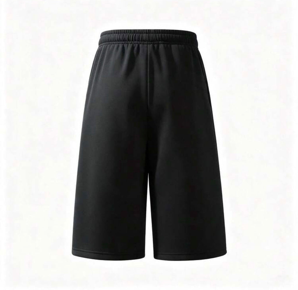 Inflation trending long jogger shorts in black, featuring a comfortable elastic waistband and tapered fit, suitable for casual wear.