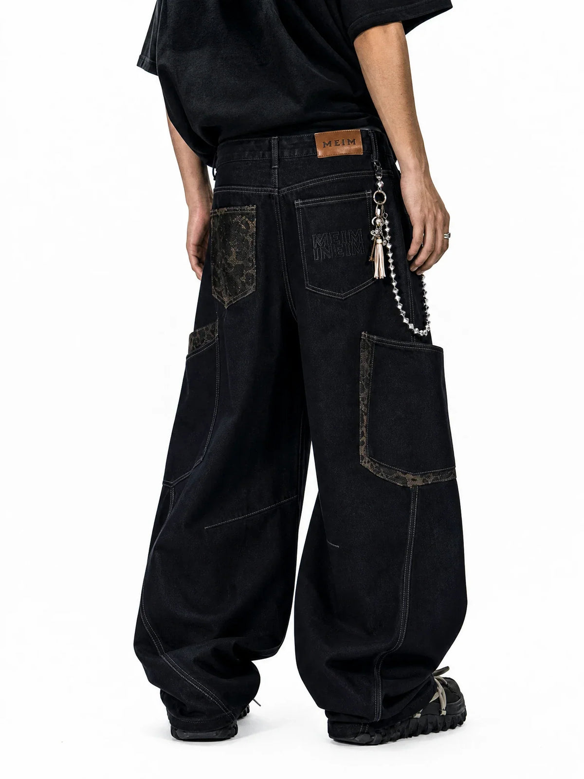 Leopard patchwork barrel jeans by INFLATION featuring bold animal print and relaxed fit, showcasing the stylish streetwear design.